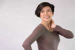 Middle aged woman is pleased with her body after breast reconstruction surgery